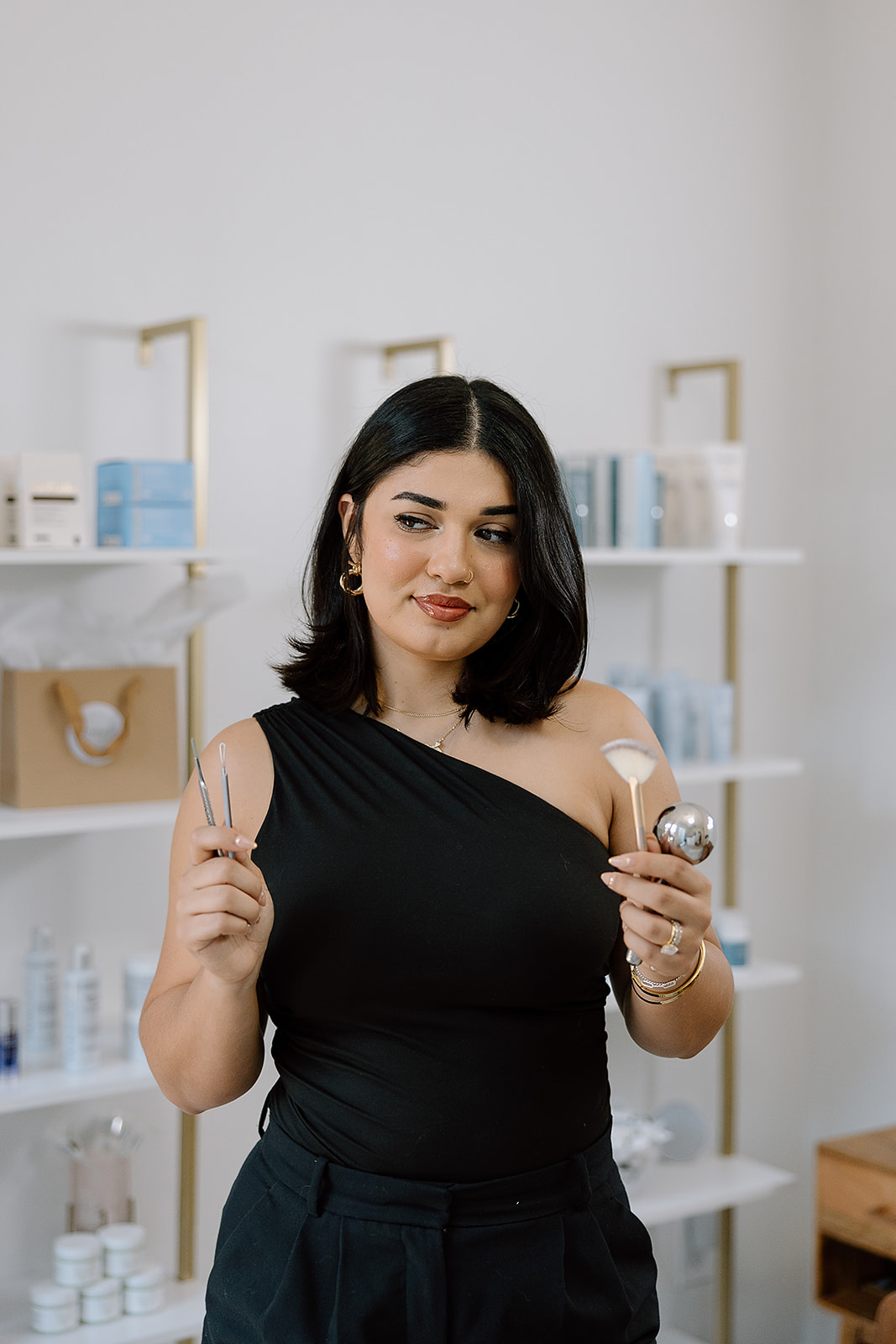 Maria holding esthetician tools